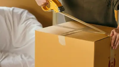 Person taping up a box