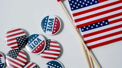 Vote pins next to American flags