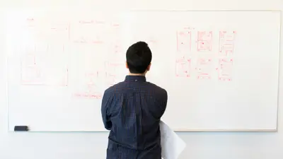 Person looking at drawing on whiteboard