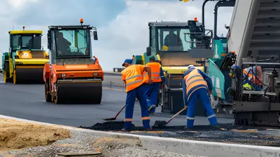 People paving a street