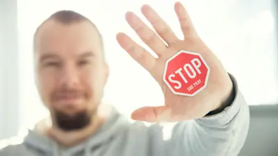 Person with stop sign sticker on their hand