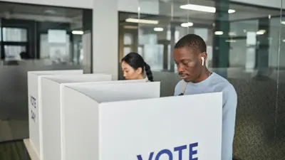 People in voting booths